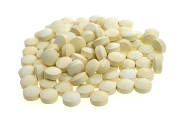 Iron pills on white background