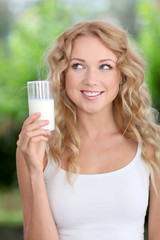 Blond woman drinking fresh milk