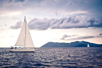 Sailing ship yachts with white sails