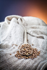 Obraz na płótnie Canvas raw lentils over spoon and woolen