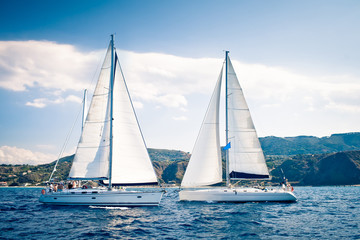 Sailing ship yachts with white sails