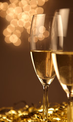 Christmas glasses of Champagne and golden background