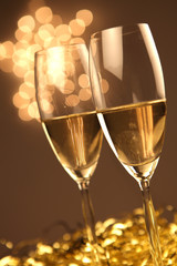Christmas glasses of Champagne and golden background