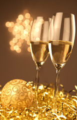 Christmas glasses of Champagne and golden background