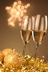 Christmas glasses of Champagne and golden background