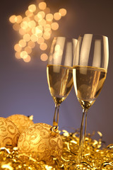 Christmas glasses of Champagne and golden background