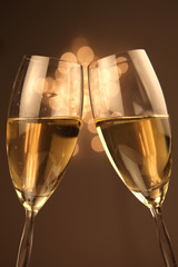 Christmas glasses of Champagne and golden background