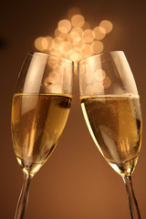 Christmas glasses of Champagne and golden background