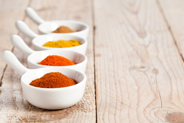 Assorted spicy powders in white bowls