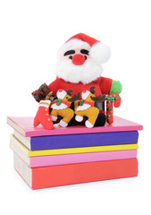 Santa Claus doll on a pile of books