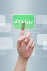 hand pushing strategy button on a touch screen interface