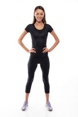 Fototapeta premium young fitness trainer standing isolated over white background