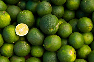 pile of Lime fruits with one of them cut open