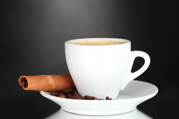 cup of coffee, cinnamon and coffee beans on black background