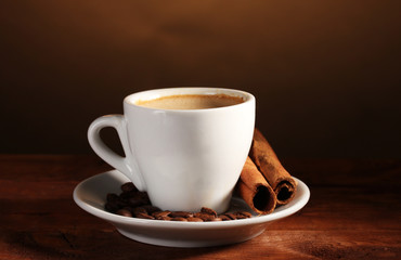 cup with coffee, cinnamon and coffee beans