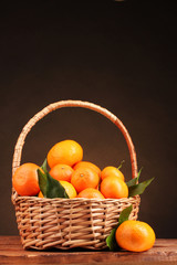 tangerines with leaves in a beautiful basket