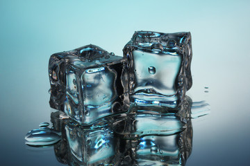 Melting ice cubes on blue background