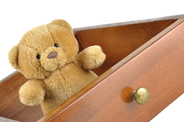 Teddy bear in a wooden drawer