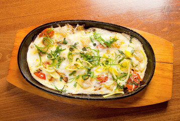 Fried eggs with vegetables and spring onions