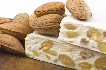 Nougat with almonds on the wood