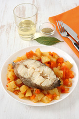 boiled fish and vegetables with glass of wine