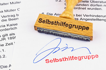 Holzstempel auf Dokument: Selbsthilfegruppe