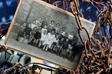 Photo of sad children in a group between rusty chains