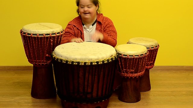 down syndrome woman play in djembe