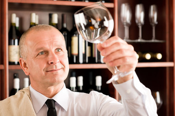 Wine bar waiter clean glass looking at