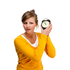 Young woman holding alrm clock isolated on white