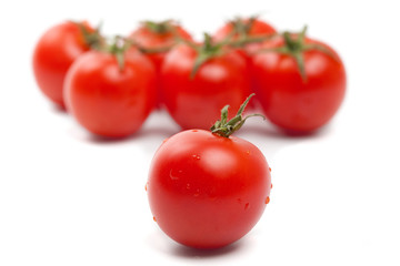 Close-up of wet Cherry tomatoes on white