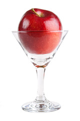 Red apple fruit in cocktail glass, isolated on white