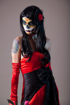 Sugar skull girl in red evening dress