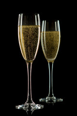 A glass of champagne, isolated on a black  background.