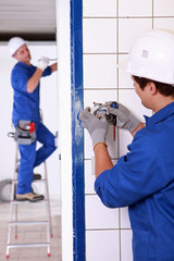 Electrician wiring a wall socket