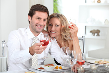 Happy couple eating meal at table