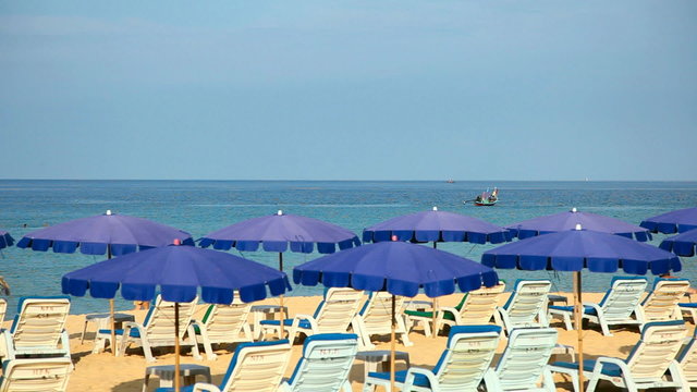 Sandy beach with Loungers and Umbrellas.