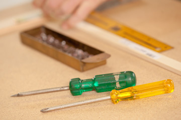 screwdriver on a wood workbench in front of a burin