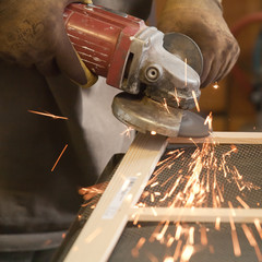 grinding the head of screws making sparks