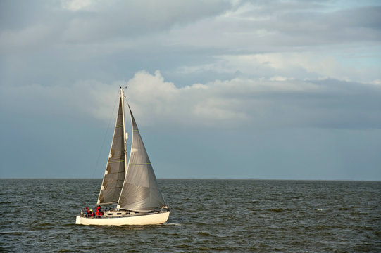 Sailing boat sailing on a lake in fall