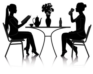 two girls at a table in a cafe