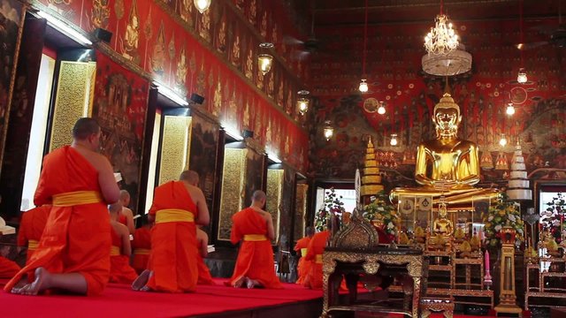 buddhist monks pray in temple