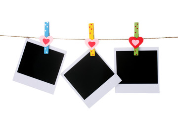 Photo paper hanging on the clothesline isolated on white