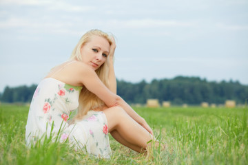Fototapeta na wymiar young woman sitting on the grass