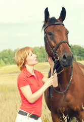 Obraz premium young pretty girl with her horse