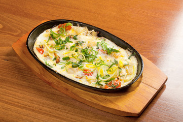 Fried eggs with vegetables and spring onions