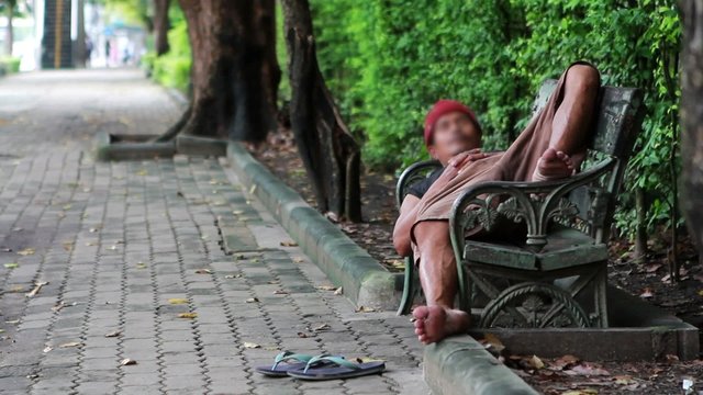 homeless man sleep on bench