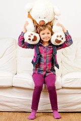 Cute girl playing with teddy bear