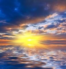 Naklejka na ściany i meble dramatic sunset reflected in a water