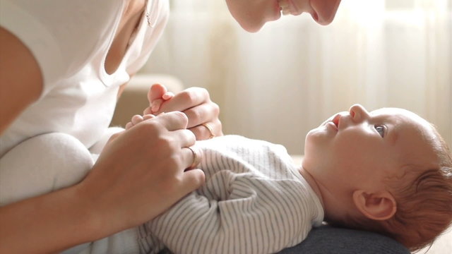 Mother kissing her child (slow motion)